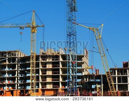 Three Cranes Near Building. Construction Site Bacjground.
