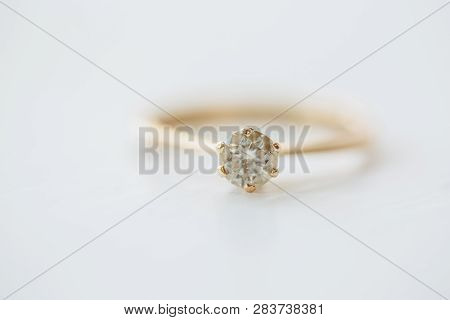 Diamond Engagement Ring On A White Surface