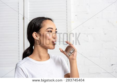 Beautiful Young Asian Woman Drinking Water In Morning