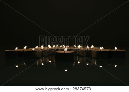 The Group Of The Candles In The Dark With The One Standing Out