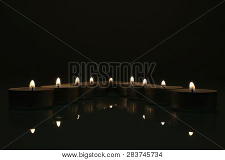 The Group Of The Candles With Reflections In The Dark