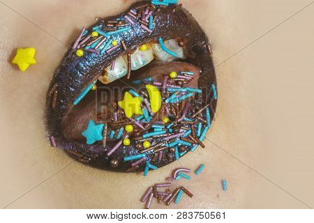 Brown Lips In Sweets Star. Colorful Sprinkles On Lips, Teeth And In Mouth. Close Up Lips And Teeth. 