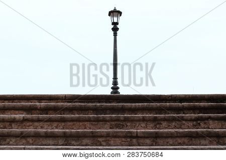Street Lamp With The White Background On The Top Of The Old Steps