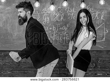 Student Lady Slapping On Teachers Buttocks With Book. Girl On Smiling Face Having Fun While Punishes