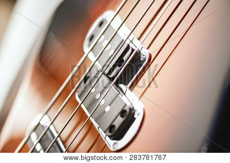 Guitar Structure. Close-up View Of Electric Guitar Body With Metal Strings And Pickups.