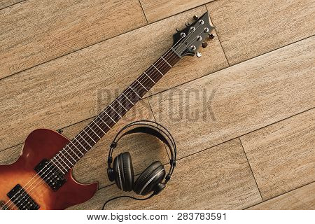 Guitar Recording. An Electric Guitar And Professional Headphones On A Wooden Floor