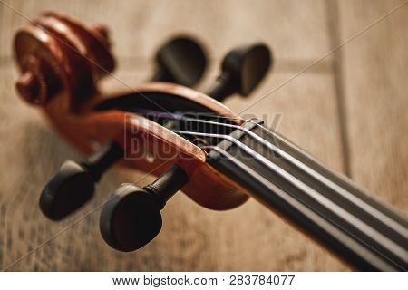 Construction Of Violin. Top View Of The Violin Neck Lying On Wooden Background