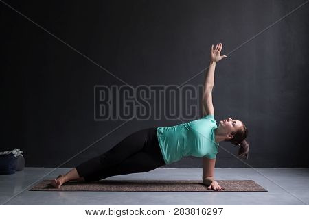 Young Woman Practices Yoga Asana Vasishthasana Or Side Plank Pose