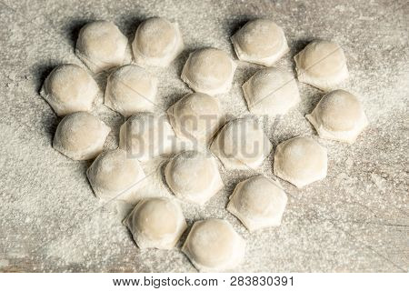 Uzbek National Food Chuchvara, Like Dumplings, Lie In The Shape Of A Heart, On A Wooden Board, In Fl
