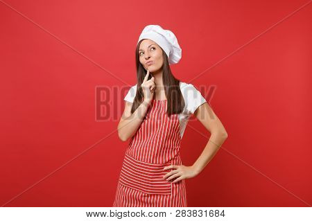 Housewife Female Chef Cook Or Baker In Striped Apron, White T-shirt, Toque Chefs Hat Isolated On Red