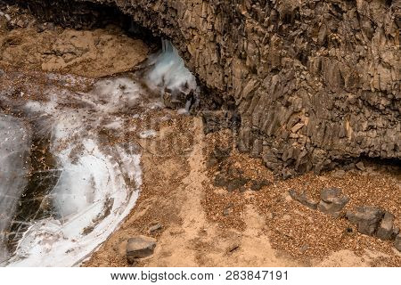 View Of Bottom Of Crater With Ice Flow And Edge Of Frozen Pond.