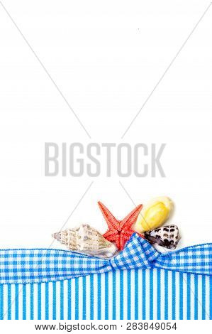 Holiday Gift Card With Blue Bow And Ribbon In The Middle Of Decoration With  Sea Shells On White Bac