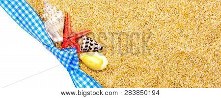 Holiday Gift Card With Blue Bow And Ribbon In The Middle Of Decoration With  Sea Shells On Backgroun