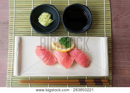 Otoro Tuna Sushi On White Plate Along With Japanese Sauce And Green Leaf Decoration, Japanese Food, 
