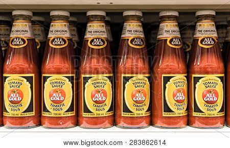 Kasane, Botswana-november 17, 2018: A Supermarket Shelf With All Gold Tomato Ketchup Bottles