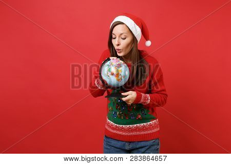 Curious Young Santa Girl In Knitted Sweater Christmas Hat Looking On World Globe In Hands Isolated O