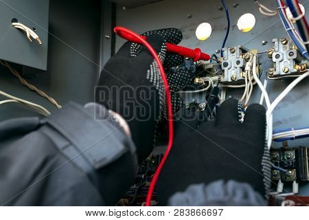 Electrician Is Checking The Voltage In The Electrical Circuit Of The Installation With A Multimeter 