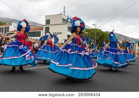 Funchal; Madeira; Portugal - April 22; 2018: A Group Of Women In Colorful Costumes Are Dancing At Ma