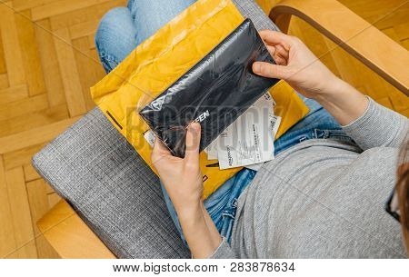 Paris, France - Nov 4, 2017: Curious Woman Unboxing On The Living Room Armchair The Amazon Prime Car