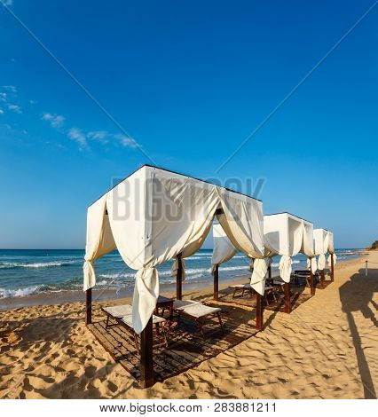 Beach Tents Canopies On Morning Paradise White Sandy Beach. The Most Beautiful Sea Sandy Beach Of Ap