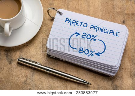 Pareto 80-20 principle concept - a sketch on a stack of index cards with a cup of coffee and  a pen