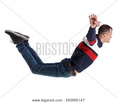 Side view of man in zero gravity or a fall. guy is flying, falling or floating in the air.  side view of person.  Isolated over white background. A man in a striped sweater falls wide apart.