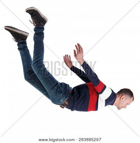 Side view of man in zero gravity or a fall. guy is flying, falling or floating in the air.  side view of person.  Isolated over white background. A man in a striped sweater falls head down.
