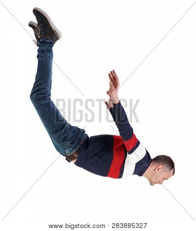 Side view of man in zero gravity or a fall. guy is flying, falling or floating in the air.   side view of person.  Isolated over white background. The guy in jeans hangs in zero gravity.