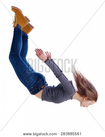 Side view of woman in zero gravity or a fall. girl is flying, falling or floating in the air.  side view of person. Isolated over white background. The girl in jeans falls down in a free fall.