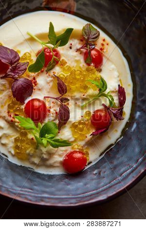 Buratta with caviar and cherry tomatoes