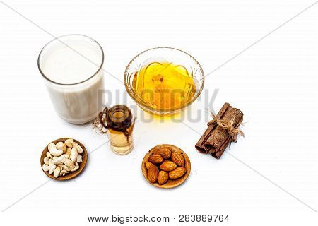 Close Up Of Popular Indian & Asian Winter Drink Isolated On White I.e Honey Milk Or Shahad Ka Dudh I