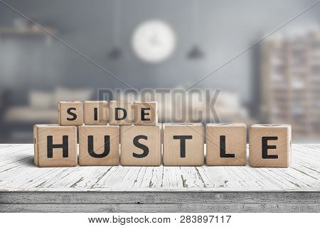 Side Hustle Sign On A Plank Table In A Decorative Room With A Clock