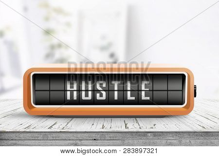 Hustle Alarm On A Wooden Table In A Bright Room With A Retro Device
