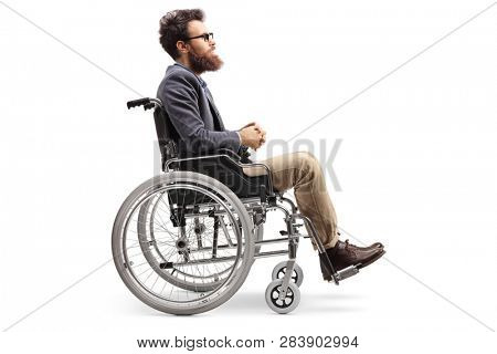 Full length profile shot of a young man in a wheechair isolated on white background