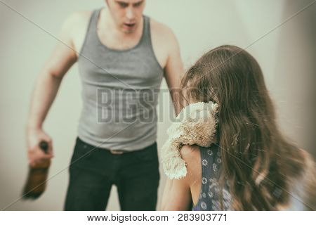 Drunk Father Pestering Frightened Little Girl With Toy.