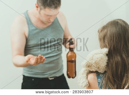 Drunk Father Pestering Frightened Little Girl With Toy.