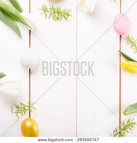 Easter Background With Easter Eggs And Spring Flowers. Top View With Copy Space