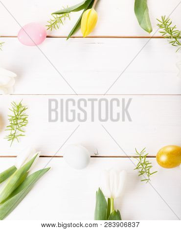 Easter Background With Easter Eggs And Spring Flowers. Top View With Copy Space