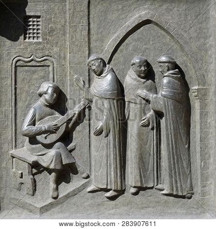 ZURICH, SWITZERLAND - JUNE 23, 2018: The 14-year-old Huldrych Zwingli making music in the Dominican Monastery in Bern, relief on the door of the Grossmunster (