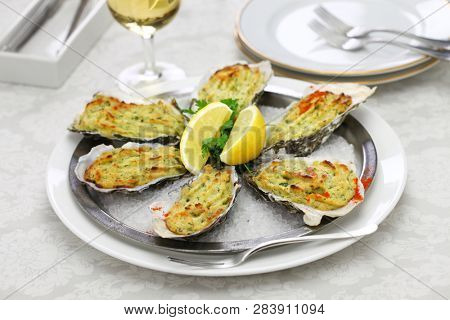 oysters rockfeller, baked oysters on half shell topped with green sauce and bread crumbs