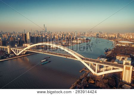 Shanghai Lupu Bridge aerial view over Huangpu River at sunset in China