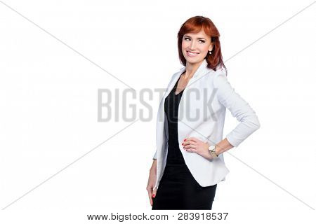 A portrait of a beautiful woman wearing classic clothes and posing over the white background in the studio. Beauty, fashion, business.