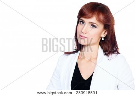 A portrait of a beautiful woman wearing classic clothes and posing over the white background in the studio. Beauty, fashion, business.