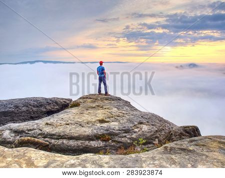 Man Lost In Thick Mist Rocks. Hiker Climbed Up Alone To Exposed Summit Above Heavy Fog. Biig Adventu