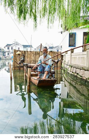 Zhouzhuang,jiangsu,china - December 14 2018 : Mannequin On A Boat Representing A Fishing Scene. Zhou