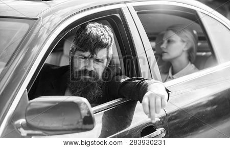 Business Woman Sit On Backseat While Bearded Driver Sit In Front. Car With Open Windows And Passenge