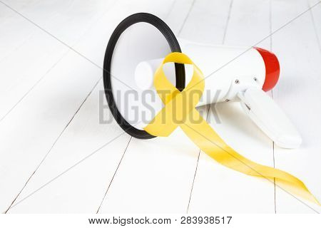 Yellow Ribbon Symbolic Color For Sarcoma Bone Cancer Awareness And Suicide Prevention On Aged Wood W