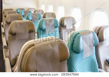 Empty Seat Rows On The Plane. Airplane Without A Passenger. The Board Of A Flying Aircraft With Empt
