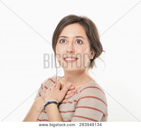Joyful Woman Holding Hands On Chest Isolated On White