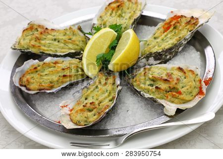 oysters rockefeller, baked oysters on half shell topped with green sauce and bread crumbs